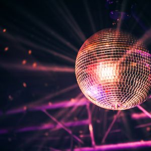 Disco ball with bright rays, night party background photo